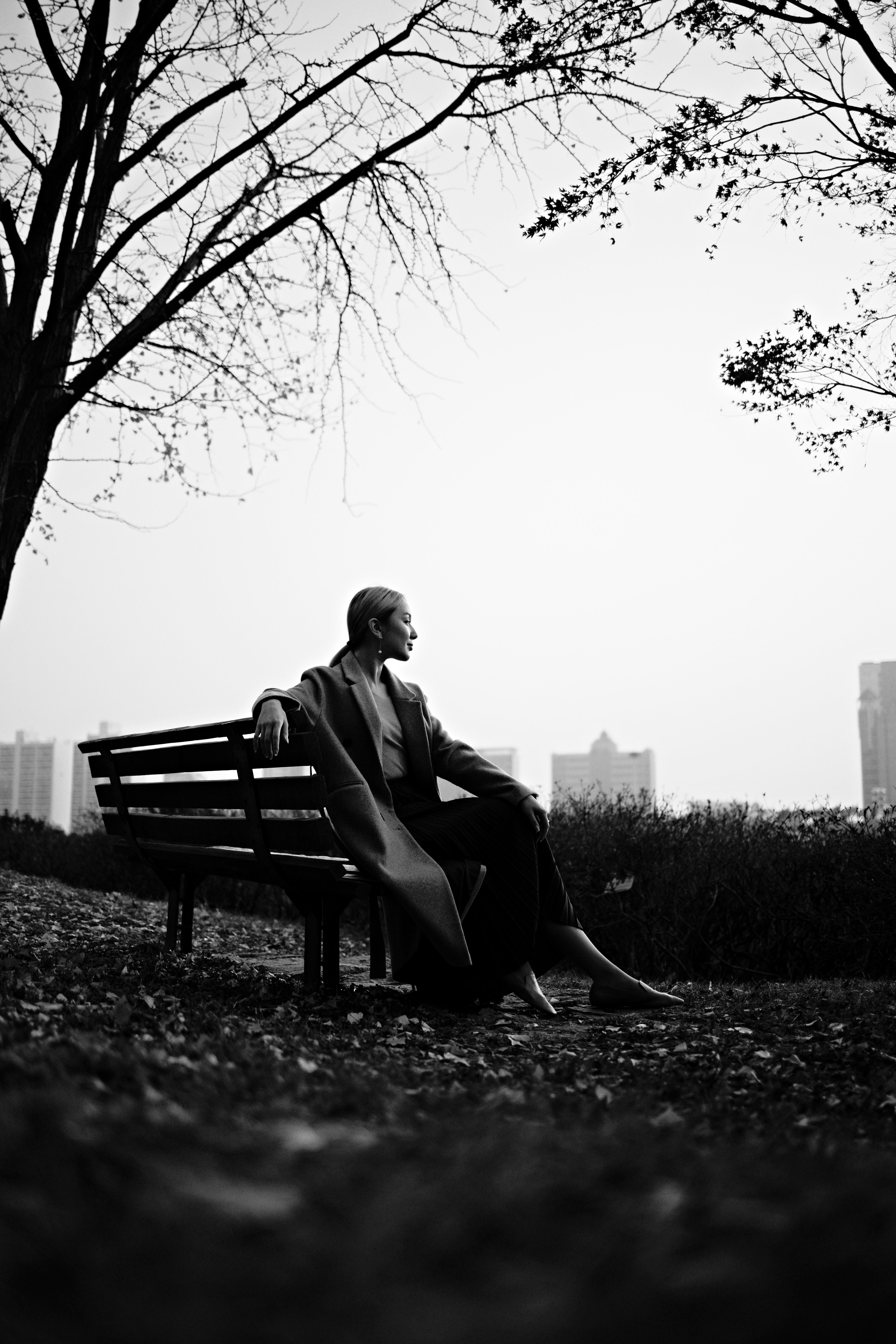 A person sitting on a bench (black and white photo)