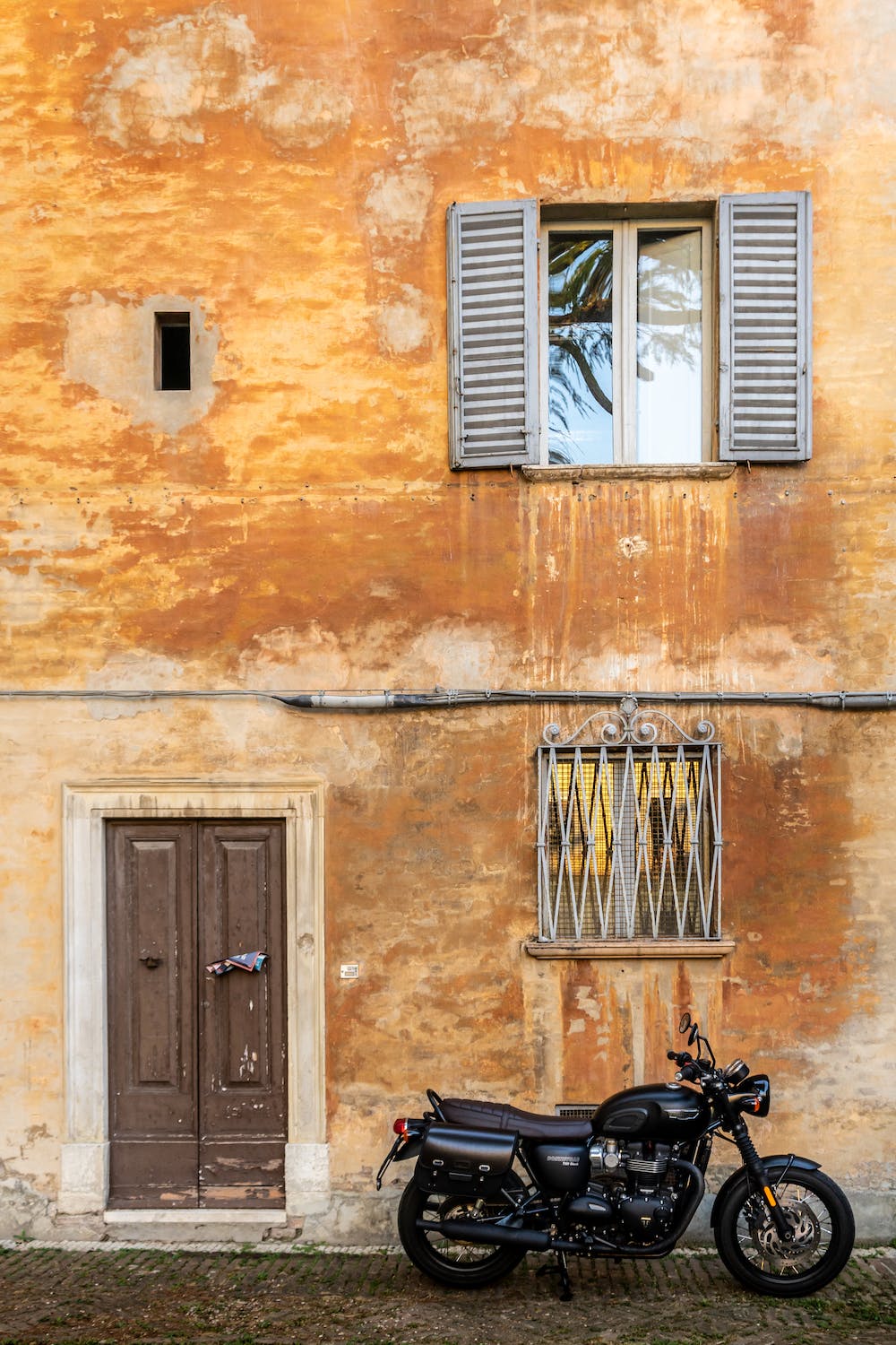 Black motorcycle in front of a building