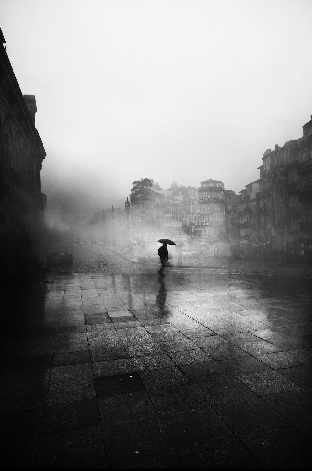Someone holding an umbrella (black and white)